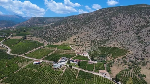 Aerial panoramic orange valley beneath rugged rocky mountain landscape Stock Footage 343946024
