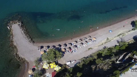 Aerial panoramic shot capturing an organized sandy beach with umbrellas. Stock Footage 343940353