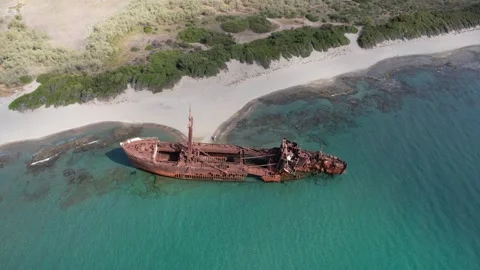 Aerial panoramic shot of rusty shipwreck on wild tropical beach coast Stock Footage 343944662