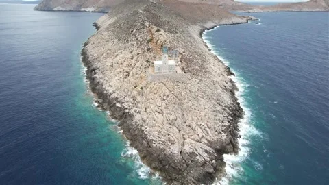 Aerial panoramic shot of stone lighthouse on narrow rocky peninsula Stock Footage 343944636