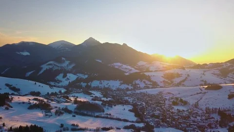 Aerial panoramic sunset over small village in winter alpine mountains nature Stock Footage 124528507