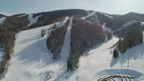Aerial panoramic top view of the ski resort with slopes, skiers and snowboarders Stock-Footage 166220909