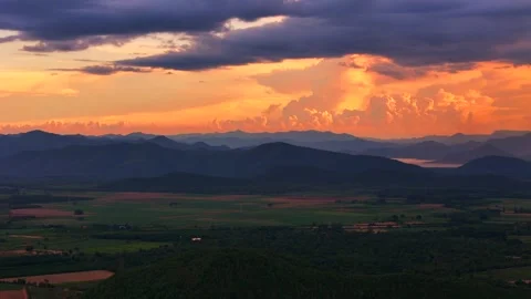 Aerial panoramic view of beautiful red sunset light hitting cloudy mountain Stock Footage 314415416