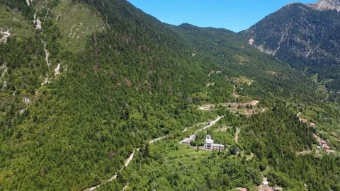 Aerial panoramic view of Byzantine monastery above forested cliff Stock Footage 343945936