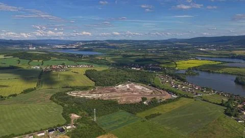 Aerial panoramic view of circular quarry and patchwork farmland, winding ri.. Stock Photos