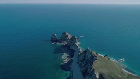 Aerial panoramic view of cliffs and huge rocks at seaside and waves crashing to Stock-Footage 167718905
