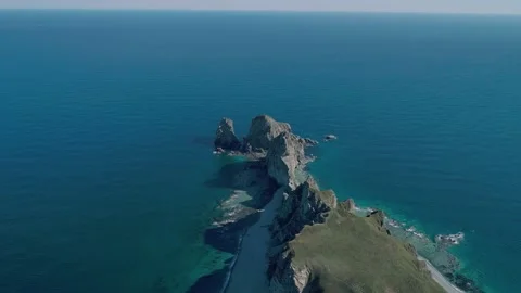 Aerial panoramic view of cliffs and huge rocks at seaside and waves crashing to Stock-Footage 167719113