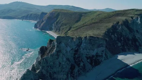 Aerial panoramic view of cliffs and huge rocks at seaside and waves crashing to Video stock 167719838