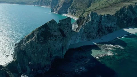 Aerial panoramic view of cliffs and huge rocks at seaside and waves crashing to Stock-Footage 167720678