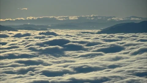 Aerial, panoramic view of clouds moving in alpine valley Stock Footage 168054432