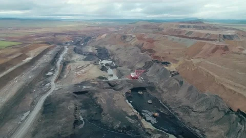Aerial panoramic view of a coal mining quarry. Heavy mining machinery and dump Stock Footage 171762898
