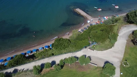 Aerial panoramic view of coastal park path and organized beach in Greece Stock Footage 343940324