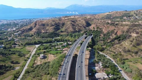 Aerial panoramic view of curved highway overpass toward sea bridge Stock Footage 343962425