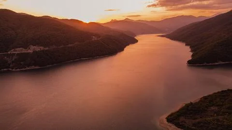 Aerial panoramic view of dramatic orange golden sunset over Zhinvali reserv.. Photos