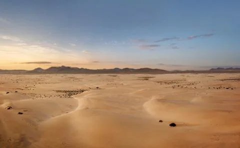 Aerial, panoramic view of an empty desert at the sunrise with copy space Stock Photos