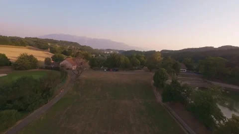 Aerial Panoramic View of Fields, Lake and Mountains at Sunset Stock Footage 341237610