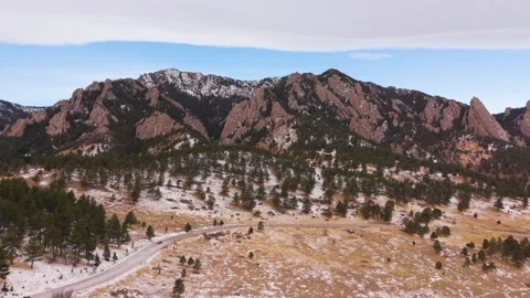 Aerial panoramic view of Flatirons with mountain road in winter Colorado Video stock 327925265