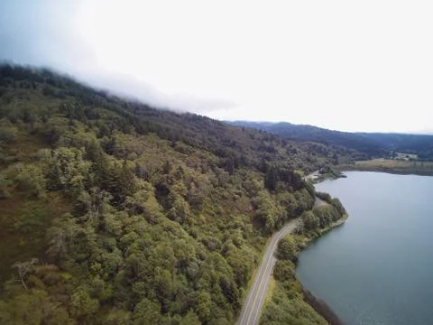 Aerial panoramic view of forest Mountain valley with empty road near the moun Stock Photos