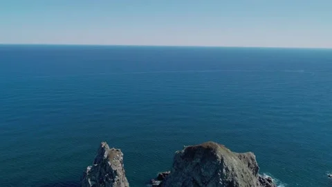 Aerial panoramic view of huge rocks at seaside and waves crashing to the coast Video stock 167719550