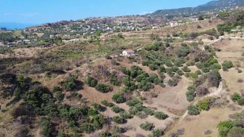 Aerial panoramic view of an isolated chapel with a distant hillside village Stock Footage 344105495