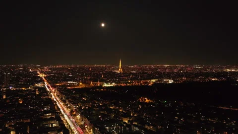 Aerial panoramic view of large city. Illuminated popular Eiffel Tower with Stock Footage 254703381