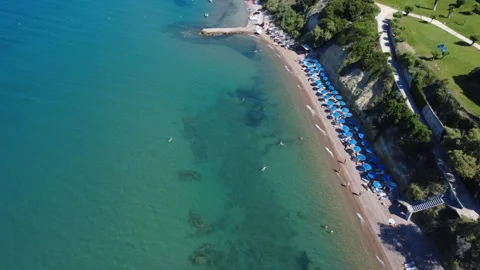 Aerial panoramic view of luxury beach and hotels on green hill in Greece Stock Footage 343940635