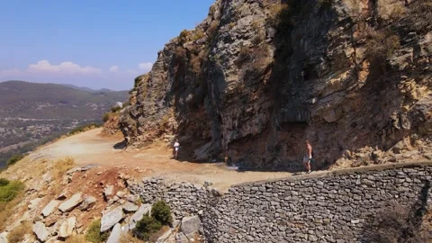 Aerial panoramic view of man walking on mountain, Oludeniz beach view Stock Footage 226156401