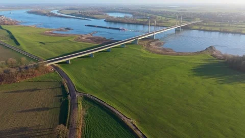 Aerial panoramic view of a modern cable-stayed bridge spanning a wide river 動画素材 331281392
