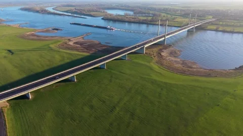 Aerial panoramic view of a modern cable stayed bridge spanning a wide river Vídeo Stock 331851912