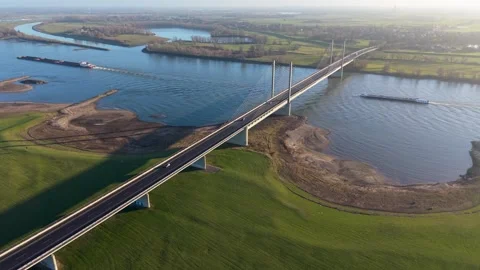 Aerial panoramic view of a modern cable stayed bridge spanning a wide river Vídeo Stock 331851927