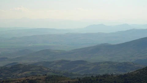 Aerial panoramic view of a mountain range under a bright blue sky Video stock 304667321