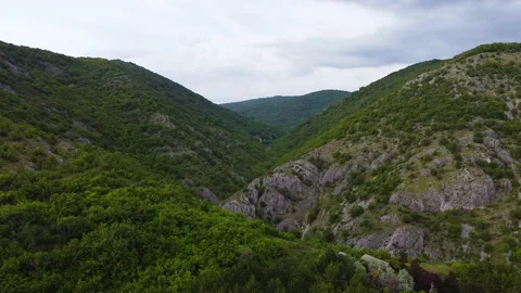 Aerial panoramic view of mountains covered by green trees in summer time Video stock 133045381
