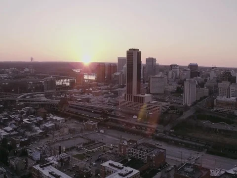 Aerial panoramic view moving across city skyline at sunset Stock Footage 77726582