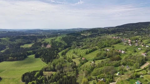 Aerial panoramic view of patchwork farmland, rolling hills, dense forests, and Stock Footage 346261735