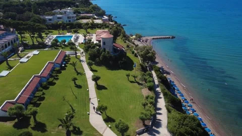 Aerial panoramic view of premium beach hotel with windmill in Greece Stock Footage 343939986
