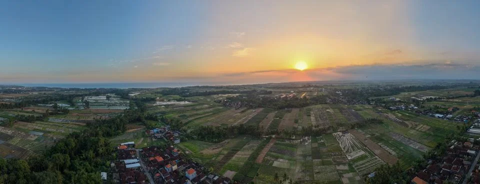 Aerial Panoramic View of Rice Fields and Village Landscape at Golden Sunset Stock Photos