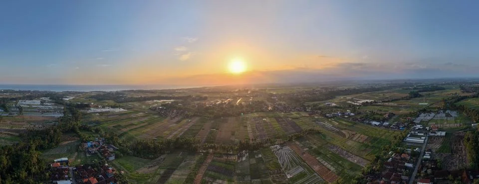 Aerial Panoramic View of Rice Fields and Village Landscape at Golden Sunset Stock Photos