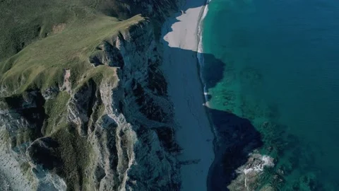 Aerial panoramic view of the rocky cliffs seaside and waves are crashing to the Stock Footage 167719959
