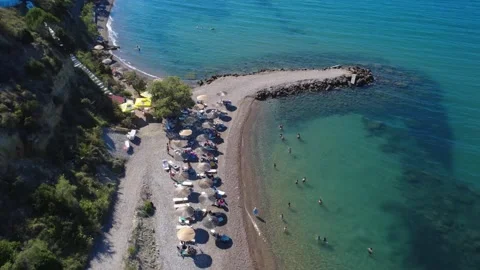 Aerial panoramic view of scenic beach protected by stone pier in Greece Stock Footage 343940530