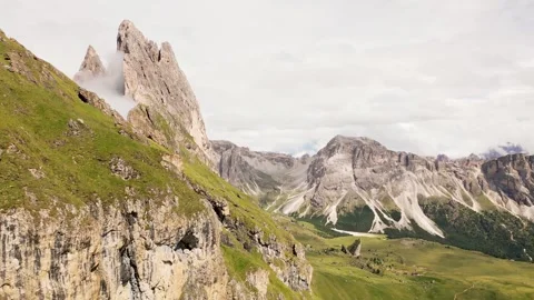 Aerial panoramic view Seceda ridge Odle peaks rise above clouds after rain .. Stock-Footage 332212798
