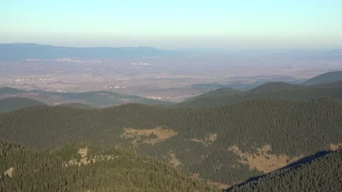 Aerial panoramic view settlements on flat plains below forested hills in Bolu Video stock 339558024