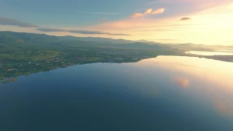 AERIAL: Panoramic view of several lakes in valley of mountains. Colorful sunrise Stock Footage 83246586