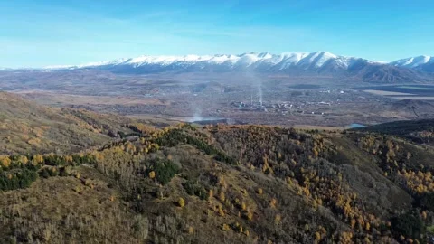 Aerial Panoramic View of Snow Capped Mountains and Golden Autumn Forests Video stock 348247371