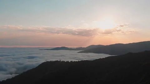 Aerial panoramic view of sun rising above horizon with clouds above forest. W Stock-Footage 146315161