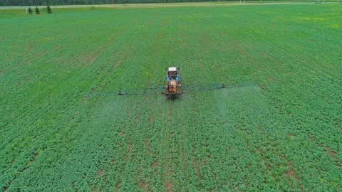 Aerial panoramic view of a tractor machine spraying the field with pesticides 스톡 동영상 197059502