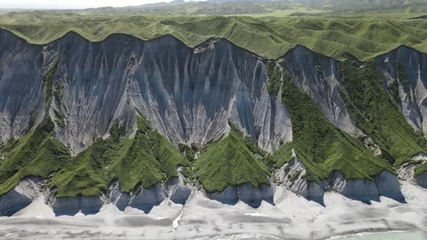 Aerial panoramic view of white cliffs of Iturup Island and shore washed by sea Video stock 242003974