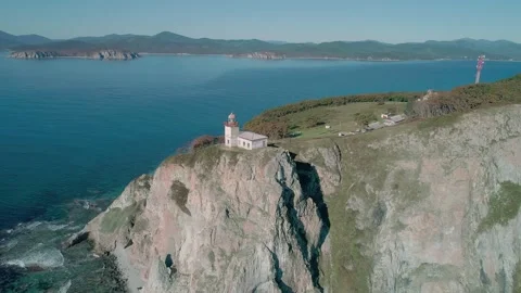 Aerial panoramic view of white lighthouse on the rocky cliff at seaside. Waves Stock Footage 167299359