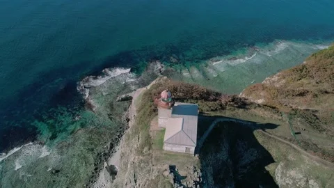 Aerial panoramic view of white lighthouse on the rocky cliff at seaside. Waves Stock Footage 167315556