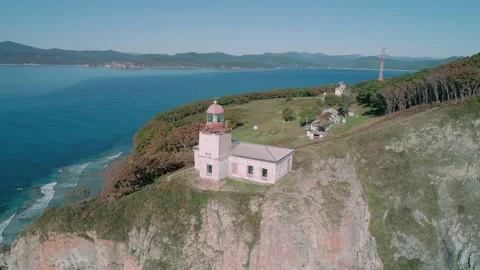 Aerial panoramic view of white lighthouse on the rocky cliff at seaside. Waves Stock-Footage 167718239
