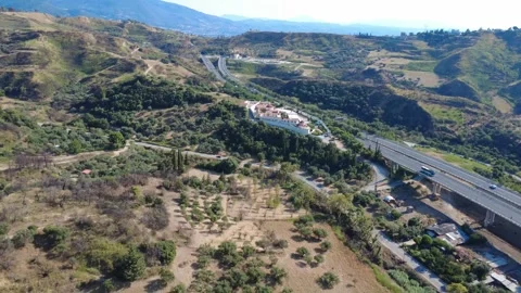 Aerial panoramic wide angle view of a highway passing a mountain monastery Stock Footage 344105017
